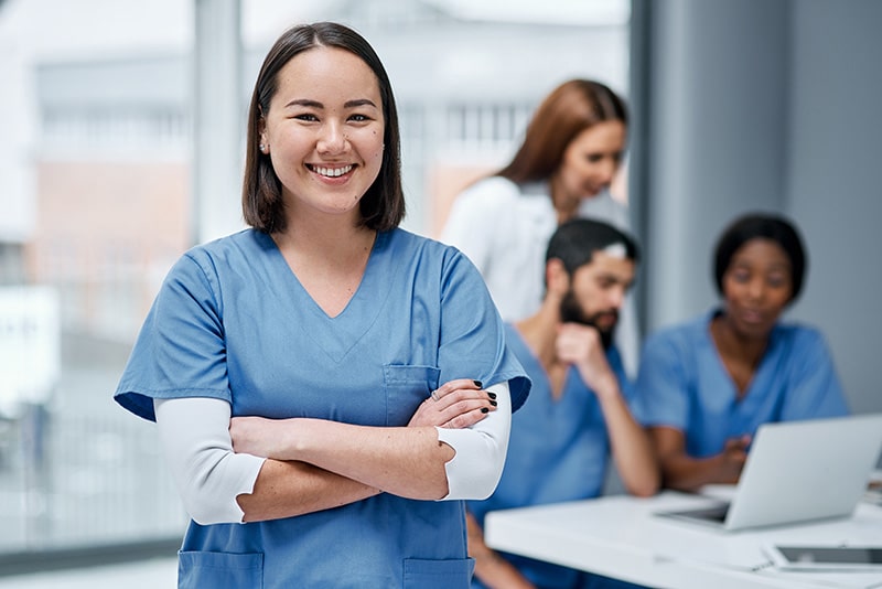 Smiling nurse with her arms crossed