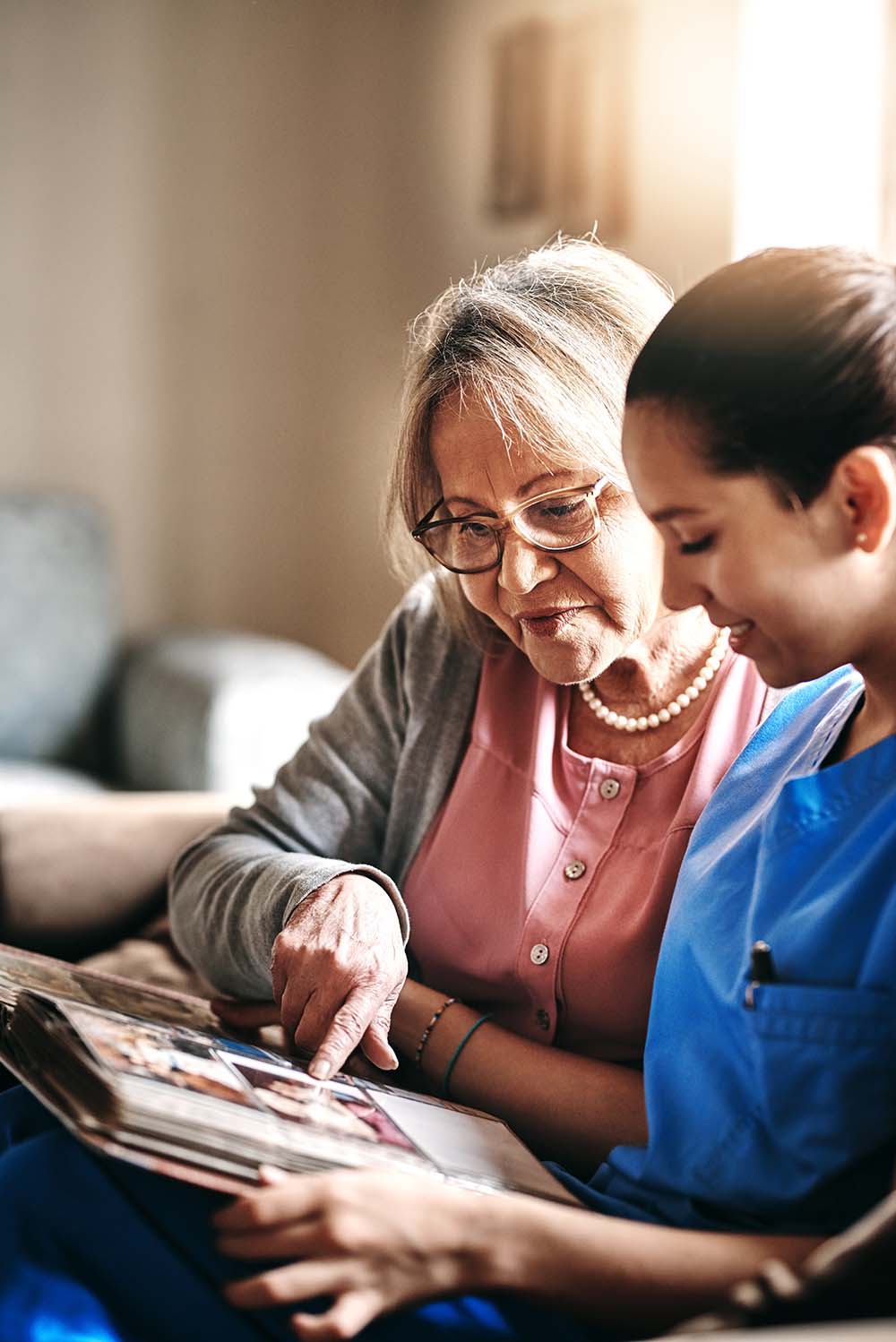 Two women looking at photo album