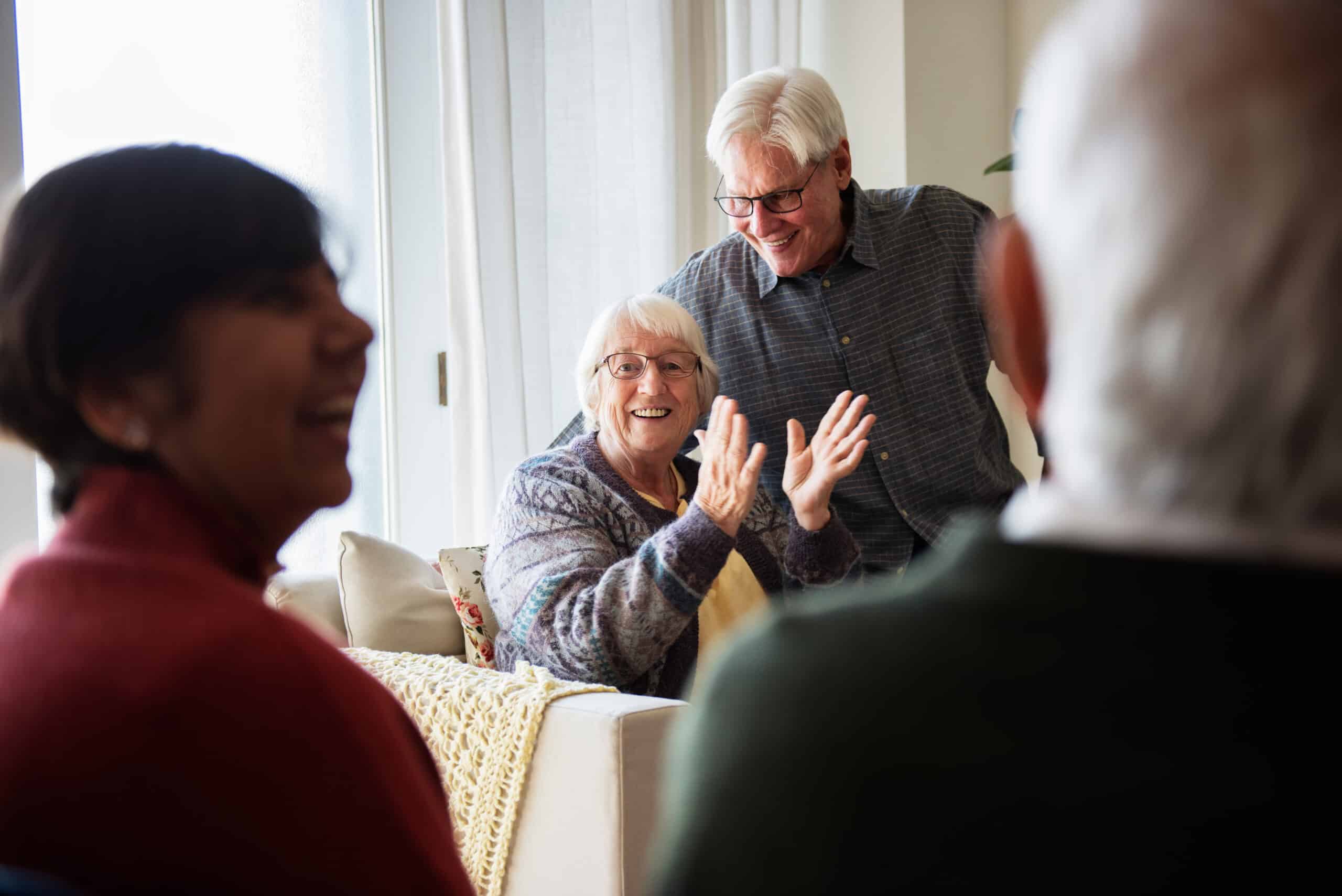 Older woman on couch clapping
