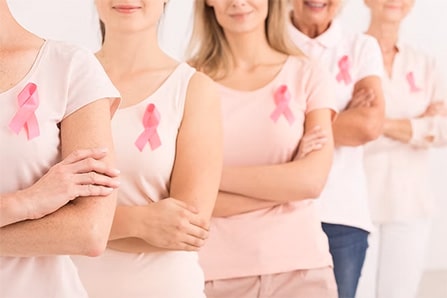 Row of women wearing cancer ribbons