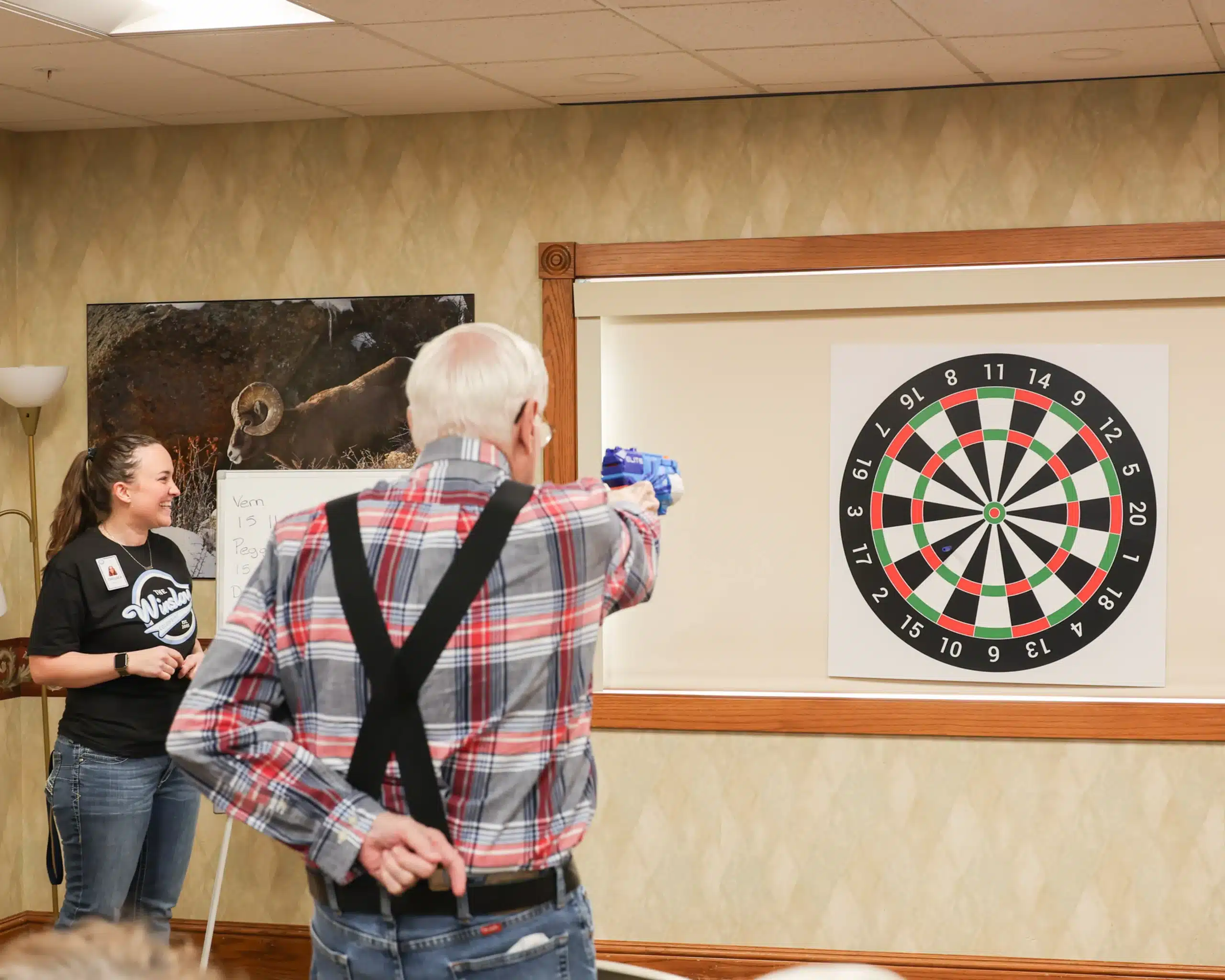 Senior playing darts