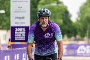Andrew on his bike finishing the Ride to End Alz 2025