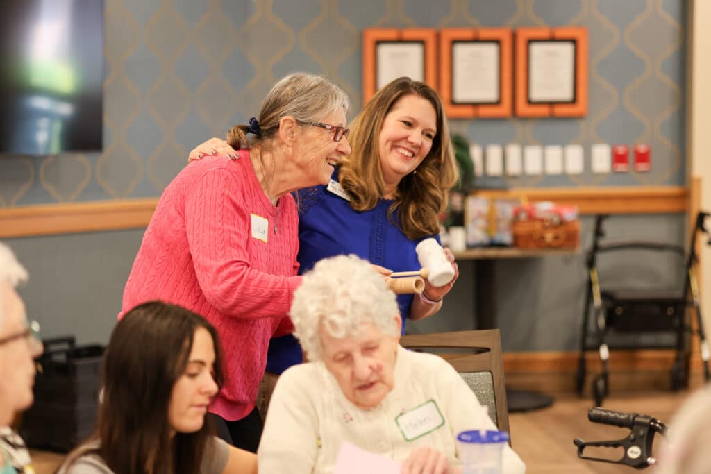 Two women dancing and singing during a Memory Cafe