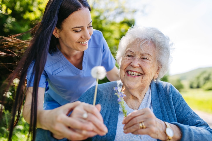 female caregiver helping resident with long-term care